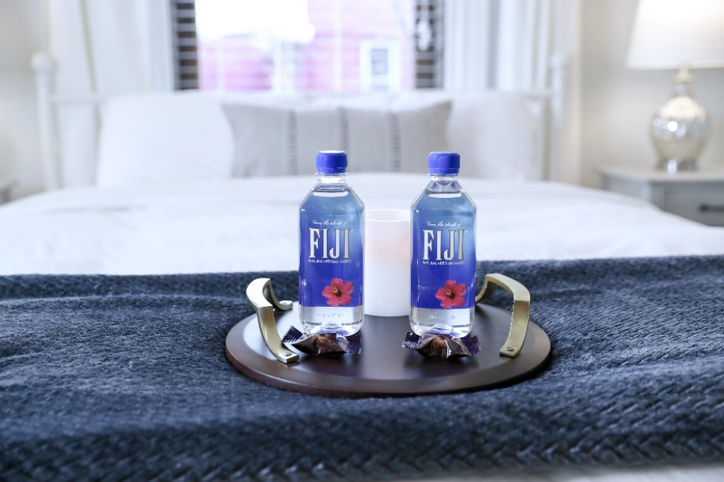 Welcome tray with FIJI water, candle, and chocolates